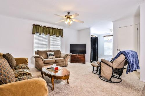 a living room with couches and a tv at Base Camp Eagle River in Eagle River