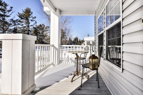 a porch of a white house with a table at Base Camp Eagle River in Eagle River