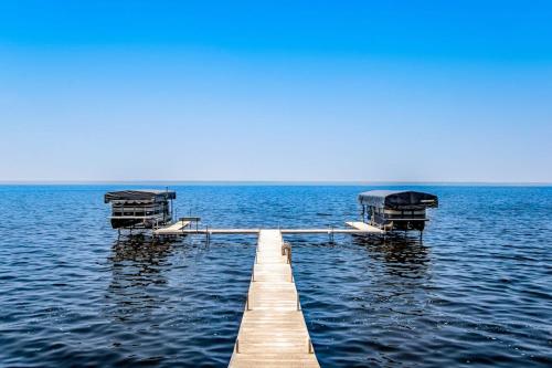 a dock in the middle of a large body of water at Peaceful Pines in New Rome