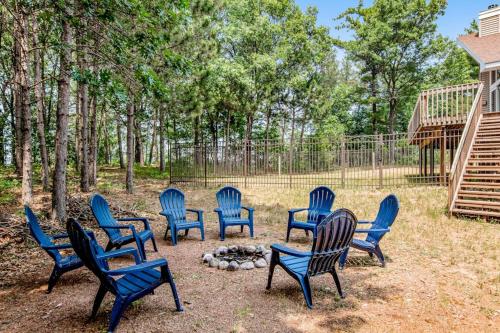 a group of blue chairs sitting around a fire at Peaceful Pines in New Rome