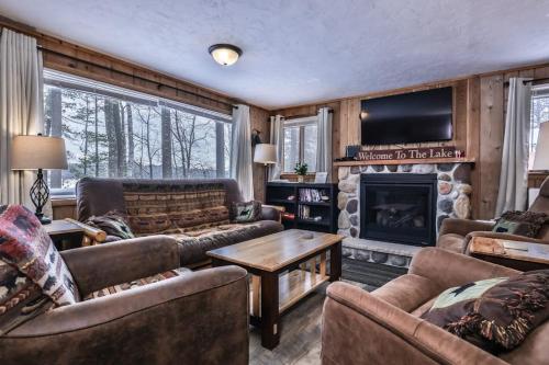 a living room with couches and a fireplace at Our Lakeside Legacy in Saint Germain