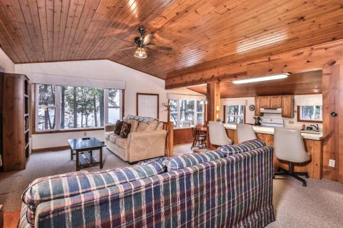 a living room with a couch and a table at Watermelon Retreat in Three Lakes