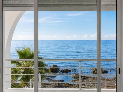 a window view of the ocean from a house at Seaside Mediterranean Duplex in Kelibia