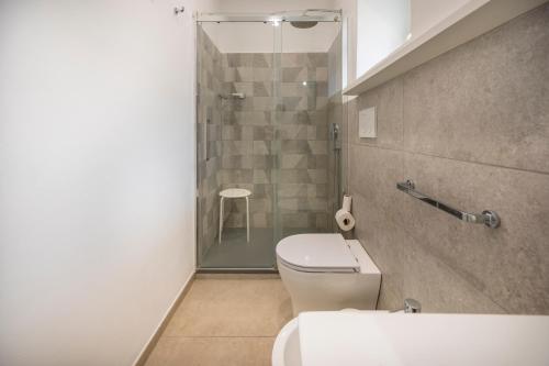 a bathroom with a shower and a toilet and a sink at Demetra in Noto