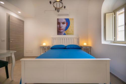 a bedroom with a bed and a painting on the wall at Demetra in Noto