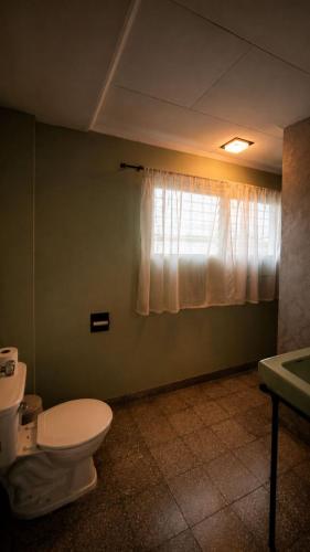 a bathroom with a toilet and a window at Napoli Centro in Santa Ana