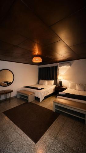 a bedroom with two beds and a mirror at Napoli Centro in Santa Ana