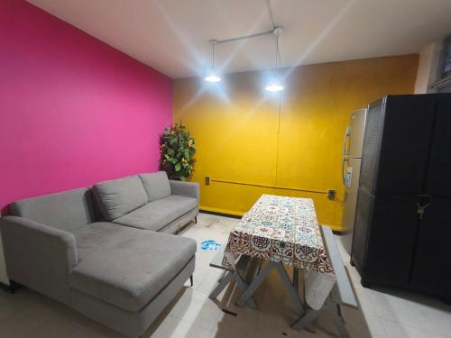 a living room with a couch and a table at Hostal Ciudad de México - Habitaciones privadas con Wi-Fi en el centro histórico in Mexico City