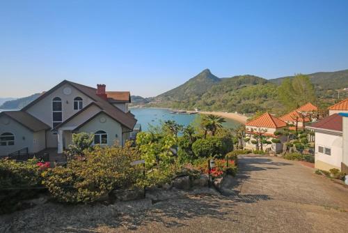 a view of a town with a body of water at namhe acro pension in Namhae