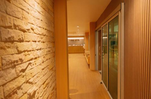 a hallway of a building with a brick wall at The Rama Hotel in Chiang Rai