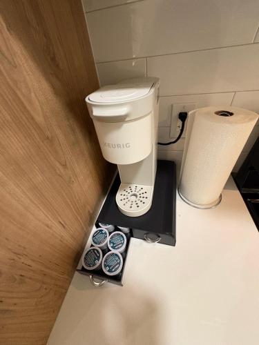 a bathroom with a coffee maker and a toilet at Boho Studio Downtown Rogers Views Heated Parking in Edmonton