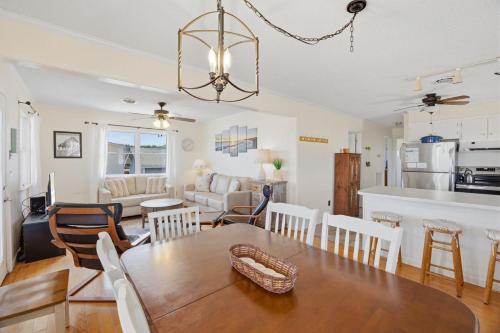 a dining room and living room with a table and chairs at 4011 - The Dog`s House in Kitty Hawk