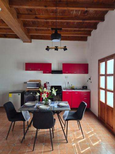 a kitchen with a table and chairs and red cabinets at Loft Juárez in Amecameca de Juárez