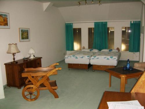 a room with a bedroom with two beds and a table at Gaestehaus Rehbein in Calbe