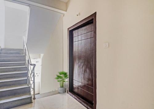 a wooden door in a room with a staircase at Via Silver Suites in Hyderabad