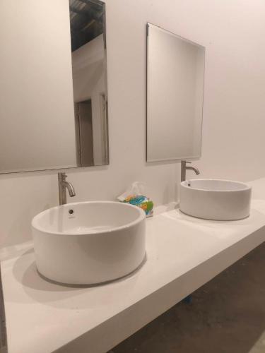 a white bathroom with two sinks and a mirror at Koala Glamping Krabi in Krabi