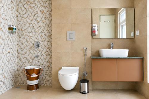 a bathroom with a toilet and a sink at The Grand Uddhav - a botique hotel in Udaipur