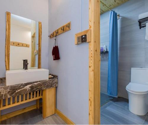 a bathroom with a sink and a toilet at Guilin Changshe Hotel in Guilin