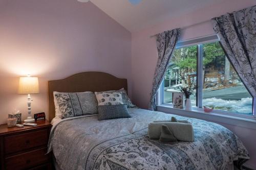 a bedroom with a large bed and a window at Sun Drenched Lakefront Cove in Monticello