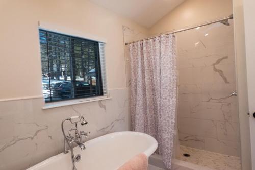 a bathroom with a bath tub and a window at Sun Drenched Lakefront Cove in Monticello