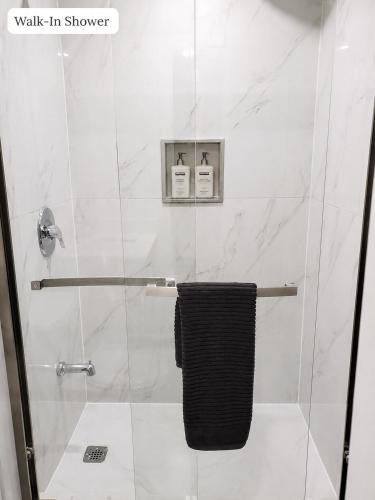 a bathroom with a shower with a towel at New 2BR Central AC Laundry Private Entry Parking in Milton