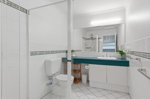 a bathroom with a toilet and a sink and a shower at Villa 3 Beach Front Tangalooma in Tangalooma