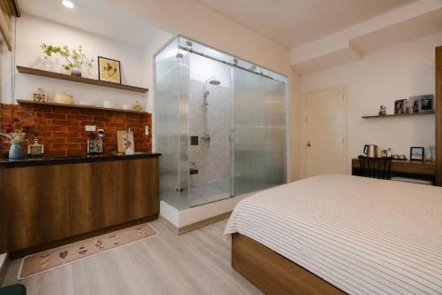 a bedroom with a shower and a bed in it at Anchie Maison Hà Nội in Hanoi