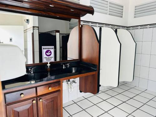 a bathroom with a sink and a mirror at The Village Inn in Carolina