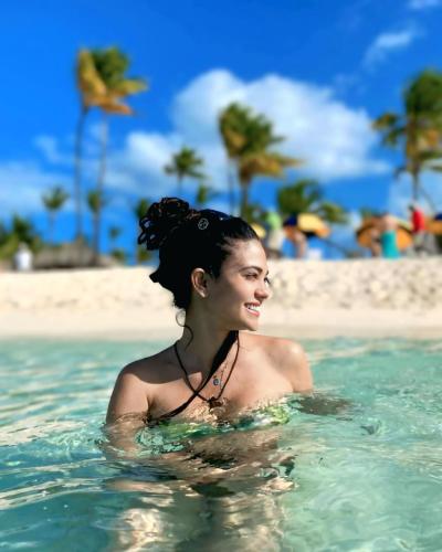 a woman in the water at the beach at Coral Beach Hotel Punta Cana in Punta Cana