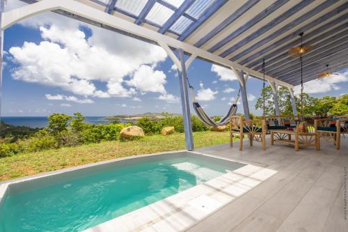 a pool in a house with a view of the ocean at La Villa de Solange - Azur in La Trinité