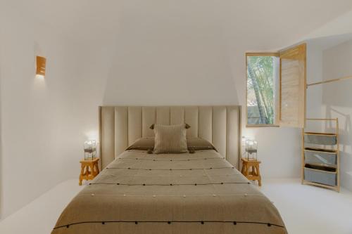 a bedroom with a large bed and a window at Casa Brasil Careyes in Careyes