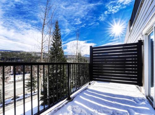 a balcony with a black fence and snow at Crestview Place Mountain View Balcony & Shuttle in Winter Park