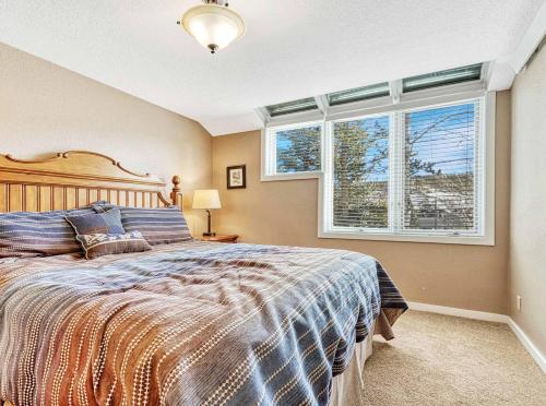a bedroom with a bed and a large window at Crestview Place Mountain View Balcony & Shuttle in Winter Park