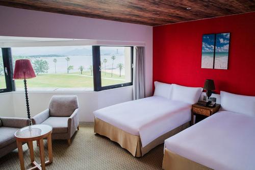 a hotel room with two beds and a window at The Luigans Spa and Resort in Fukuoka