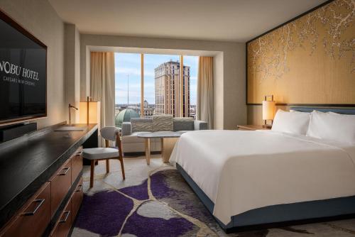 a hotel room with a large bed and a television at Caesars New Orleans, A Caesars Rewards Destination in New Orleans