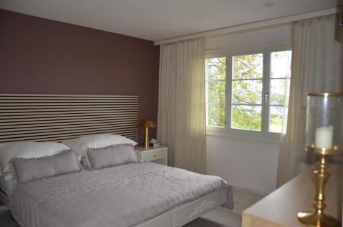 a bedroom with a white bed and a window at Auszeitloge in Nottwil