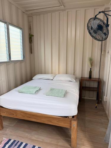 a bedroom with a bed with two pillows on it at Hotel Marea in San Juan del Sur