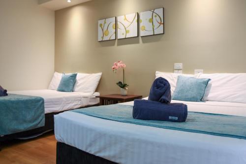 a hotel room with two beds with towels on them at Weipa Motel Resort in Weipa