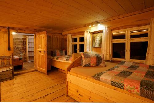 a bedroom with two beds in a log cabin at Ferienhaus Ritter in Egg