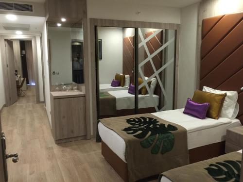 A bed or beds in a room at Delphin BE Grand Resort