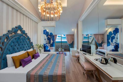 A bed or beds in a room at Delphin BE Grand Resort
