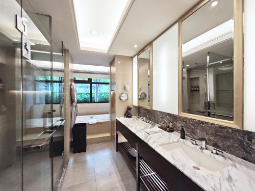 a bathroom with two sinks and a large mirror at Ascott Heng Shan Shanghai in Shanghai