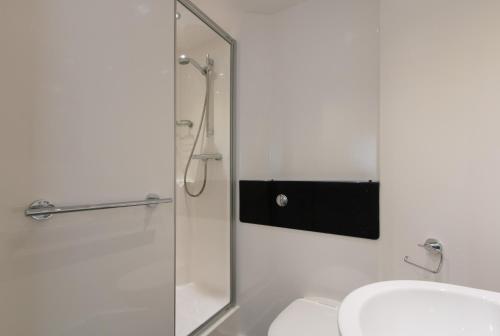 a bathroom with a shower, sink, and toilet at Destiny Student – Shrubhill (Campus Accommodation) in Edinburgh