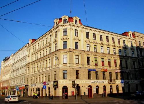 a large building on the corner of a street at Cinnamon Sally Backpackers Hostel in Rīga