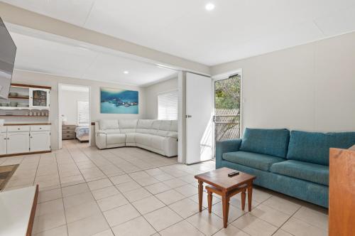a living room with a couch and a table at Curlew Corner in Cowan Cowan