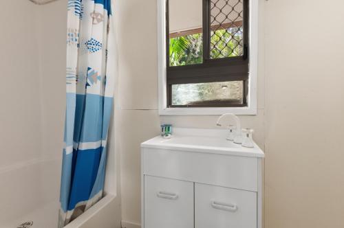 a bathroom with a sink and a window at Curlew Corner in Cowan Cowan