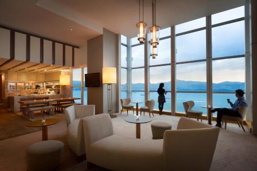 a living room with a person sitting in a chair at Jen Hong Kong by Shangri-La in Hong Kong