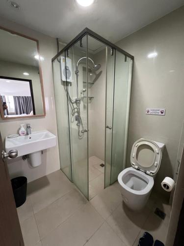 a bathroom with a shower and a toilet and a sink at Tiger Homestay in Bangkok
