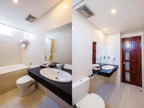 a bathroom with a sink and a toilet at GIC Land Hotel in Danang