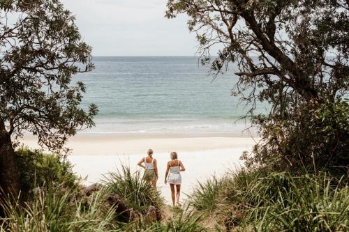 two women walking down a path to the beach at Tasman Holiday Parks - Kioloa Beach in Kioloa